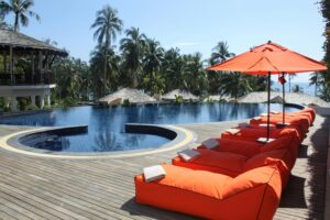 luxury pool with orange umbrella loungers; adults only escapes for luxury travel lovers