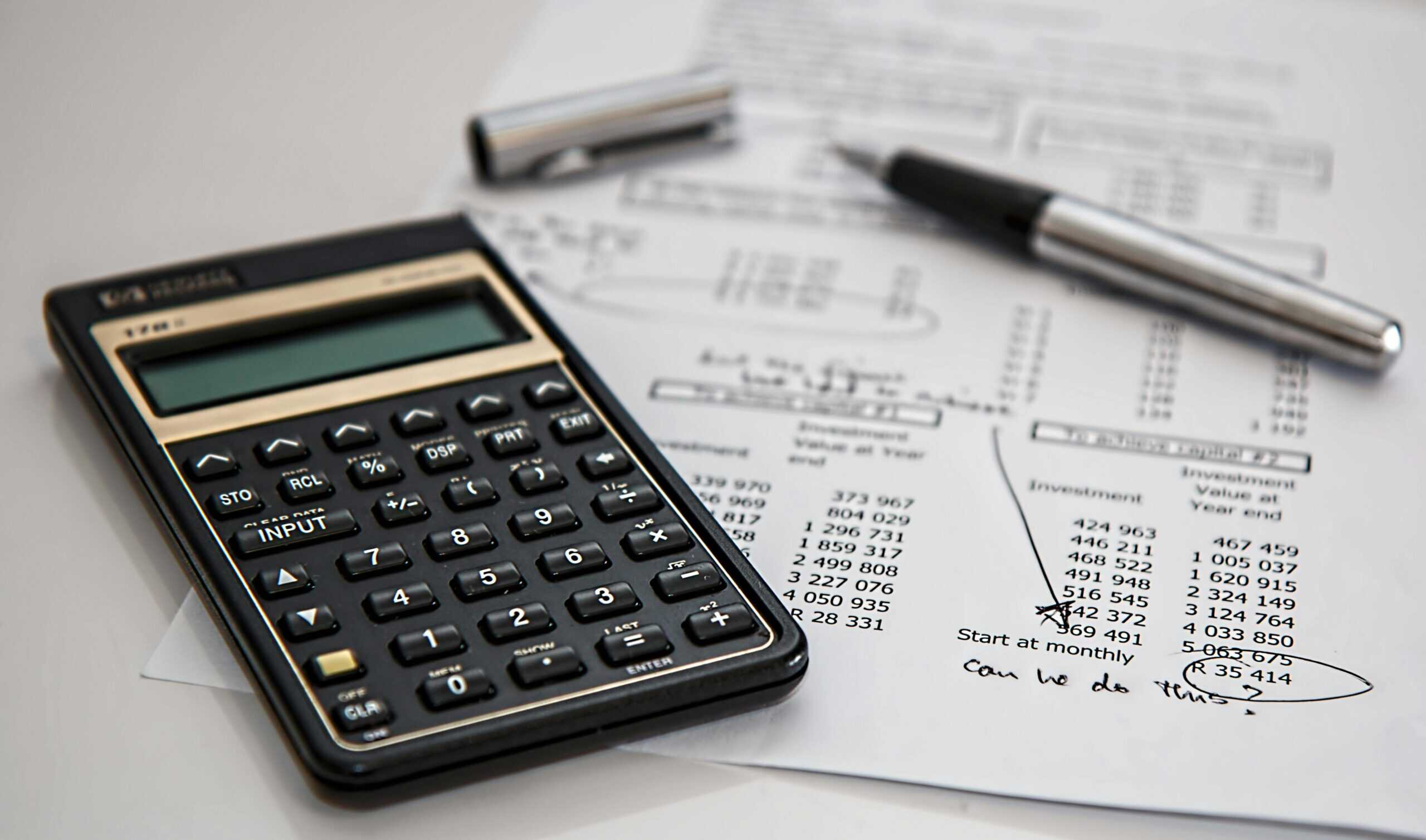 calculator with a budget sheet; how to budget your travel smartly