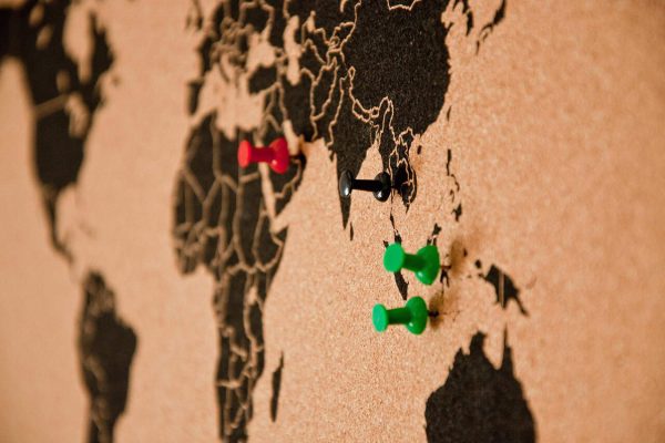 tips to travel more efficiently; world map idea board with pushpins