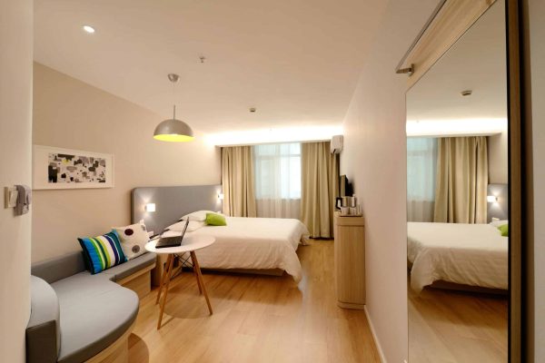 Budget your travel smartly; interior of a hotel room bedroom with lounge area